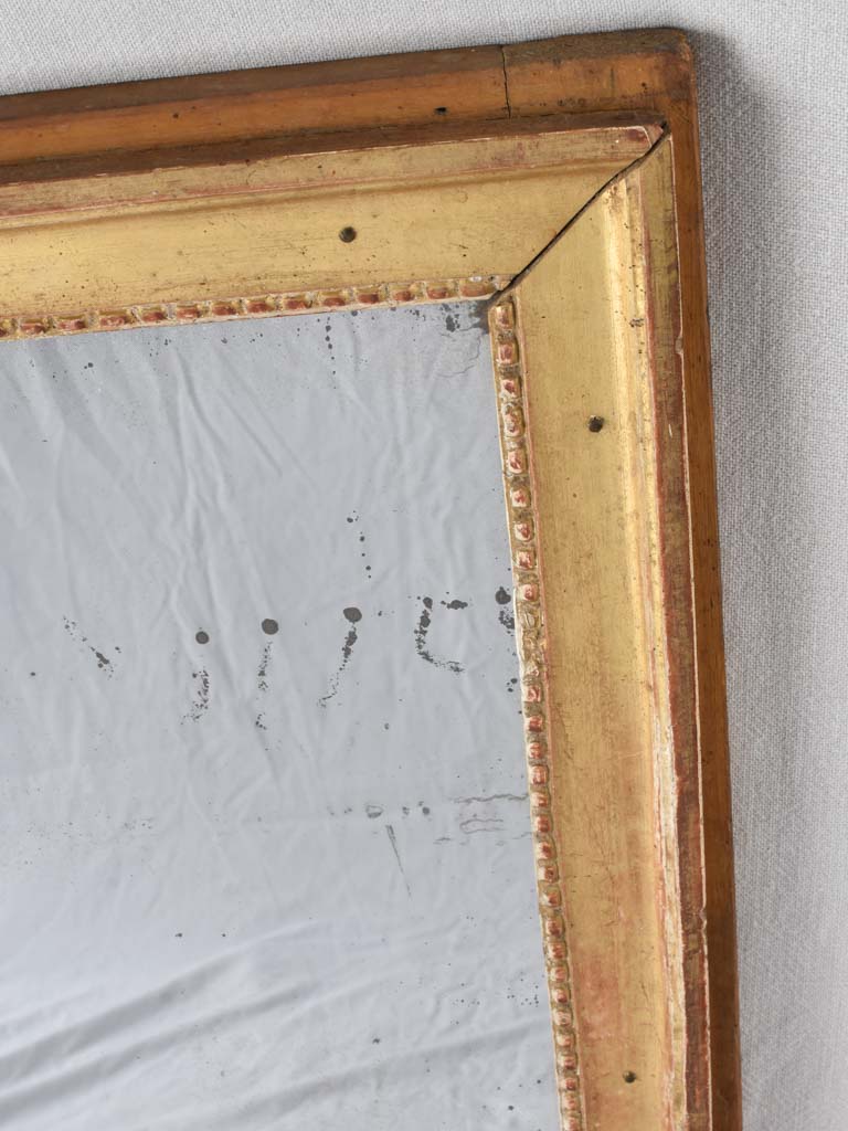 Gilded Louis XVI mirror with running pearl and mercury glass 28" x 20¾"