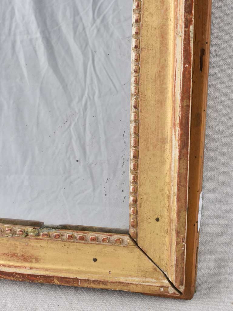Gilded Louis XVI mirror with running pearl and mercury glass 28" x 20¾"