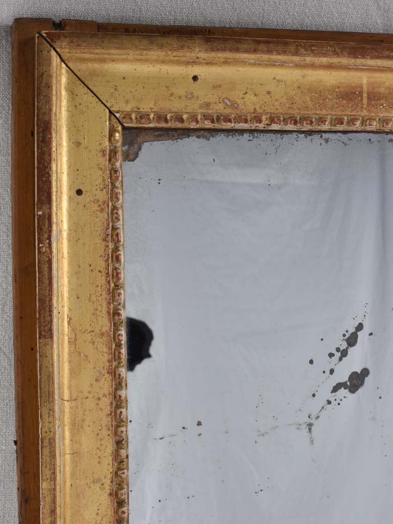 Gilded Louis XVI mirror with running pearl and mercury glass 28" x 20¾"