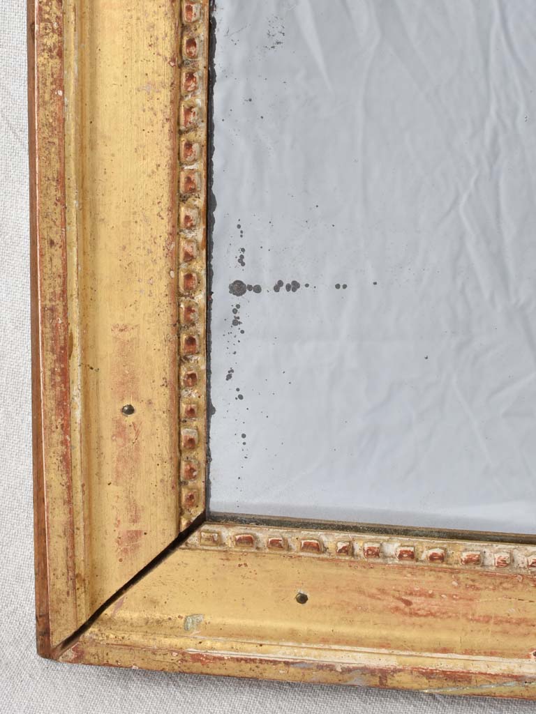 Gilded Louis XVI mirror with running pearl and mercury glass 28" x 20¾"