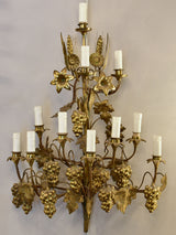 Large pair of gold wall sconces with grapes and vine leaves