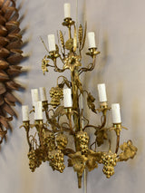 Large pair of gold wall sconces with grapes and vine leaves