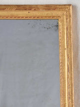 Timeworn ornate gilded Louis XVI mirror