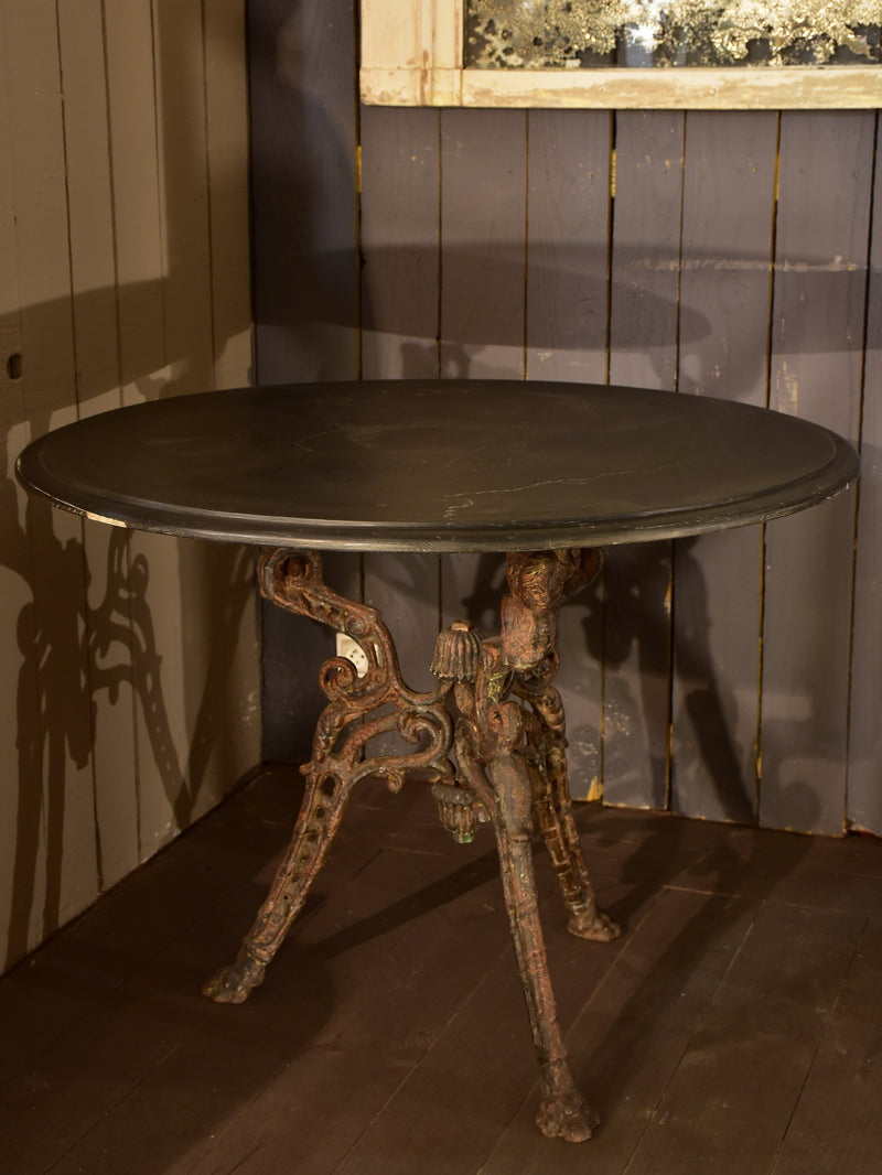 Large round table with cast iron legs and slate table top