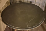 Large round table with cast iron legs and slate table top