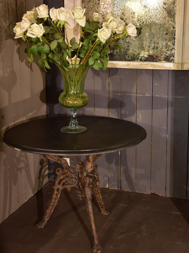 Large round table with cast iron legs and slate table top