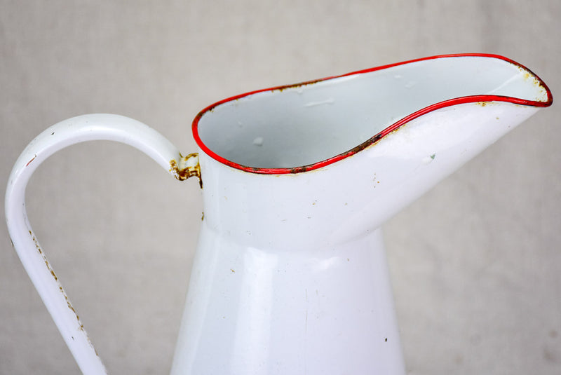 Mid century enamel pitcher - white with red rim 15"