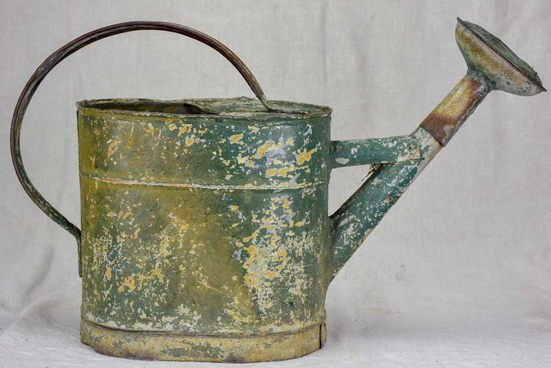 Antique French watering can with green patina