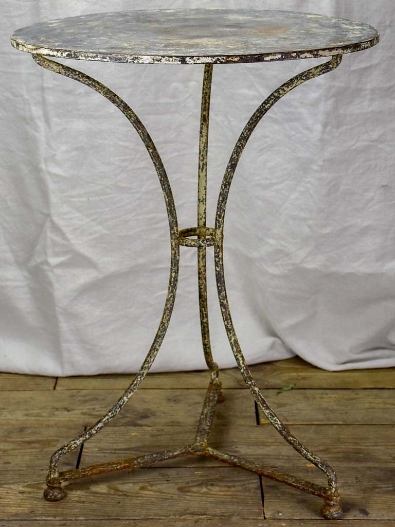 Antique French bistro table with timeworn beige patina