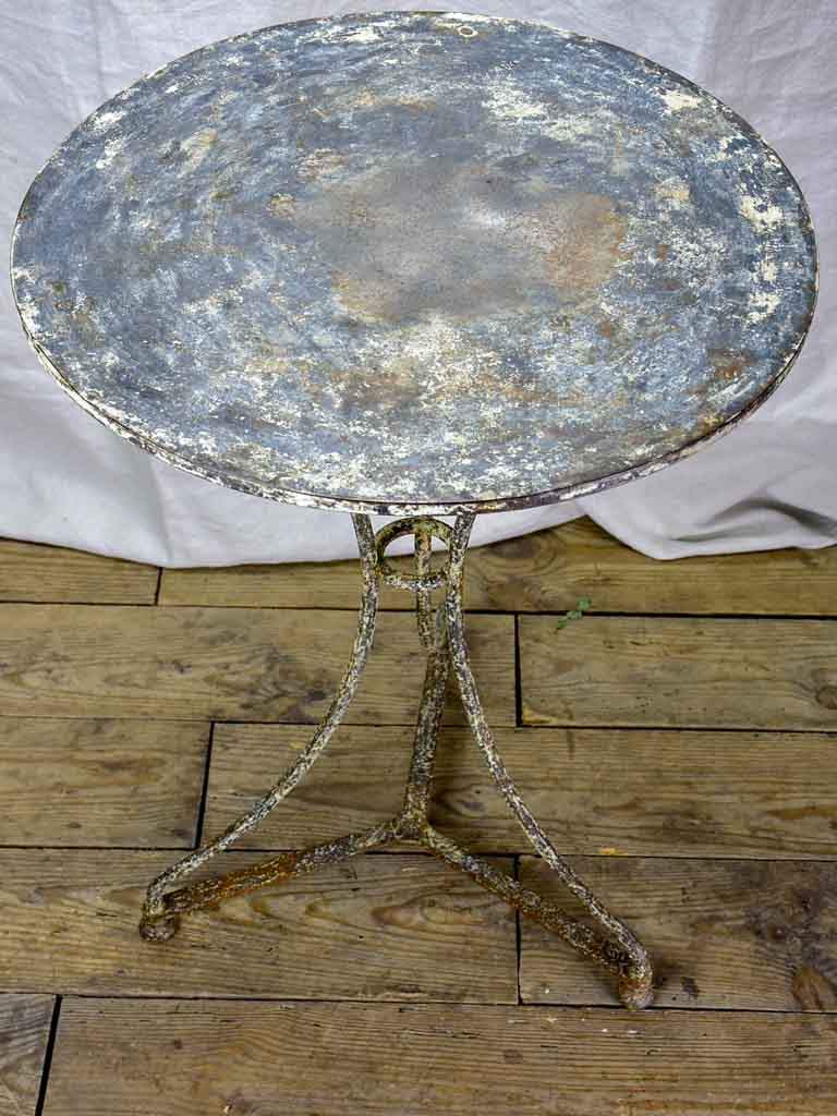 Antique French bistro table with timeworn beige patina