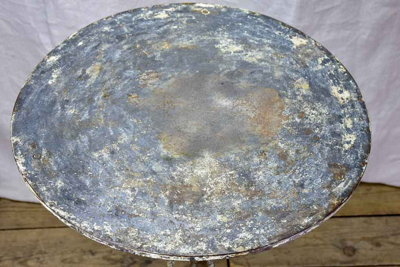 Antique French bistro table with timeworn beige patina