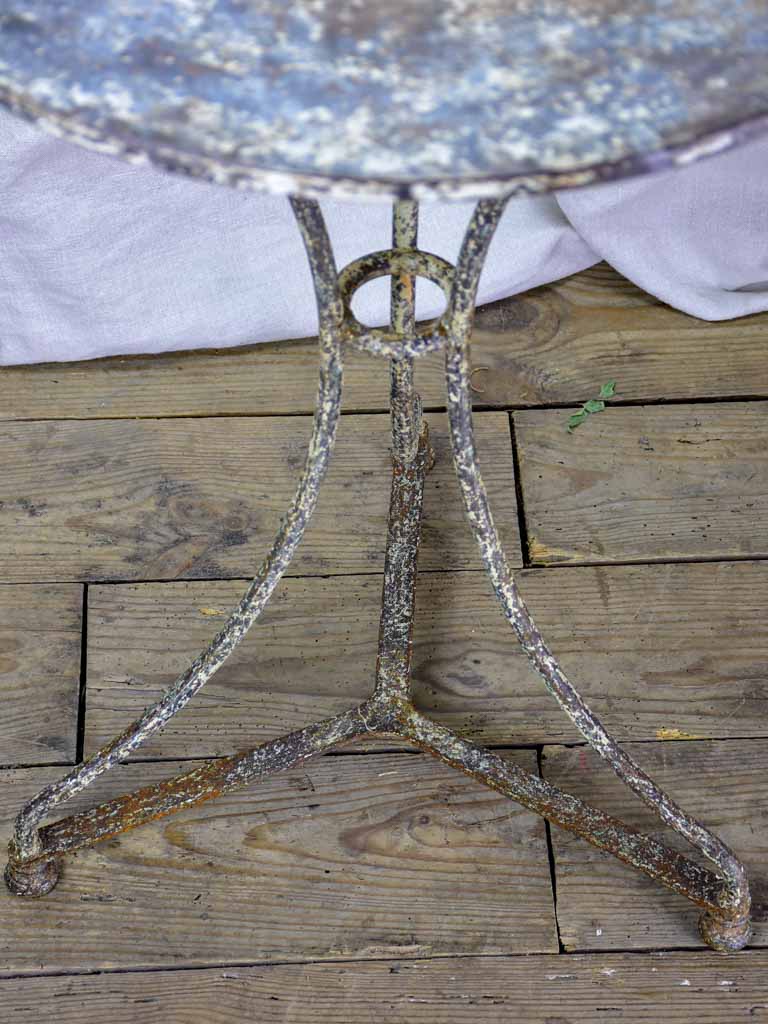 Antique French bistro table with timeworn beige patina