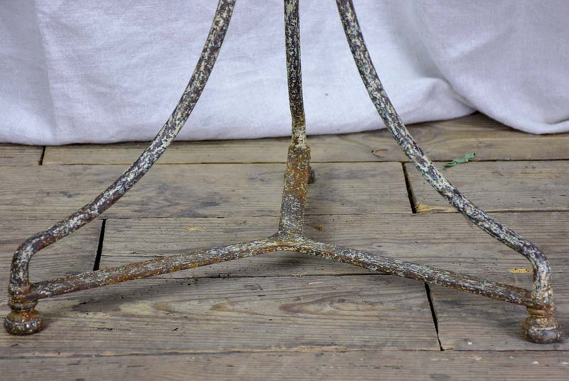 Antique French bistro table with timeworn beige patina