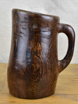 Primitive carved wooden pitcher