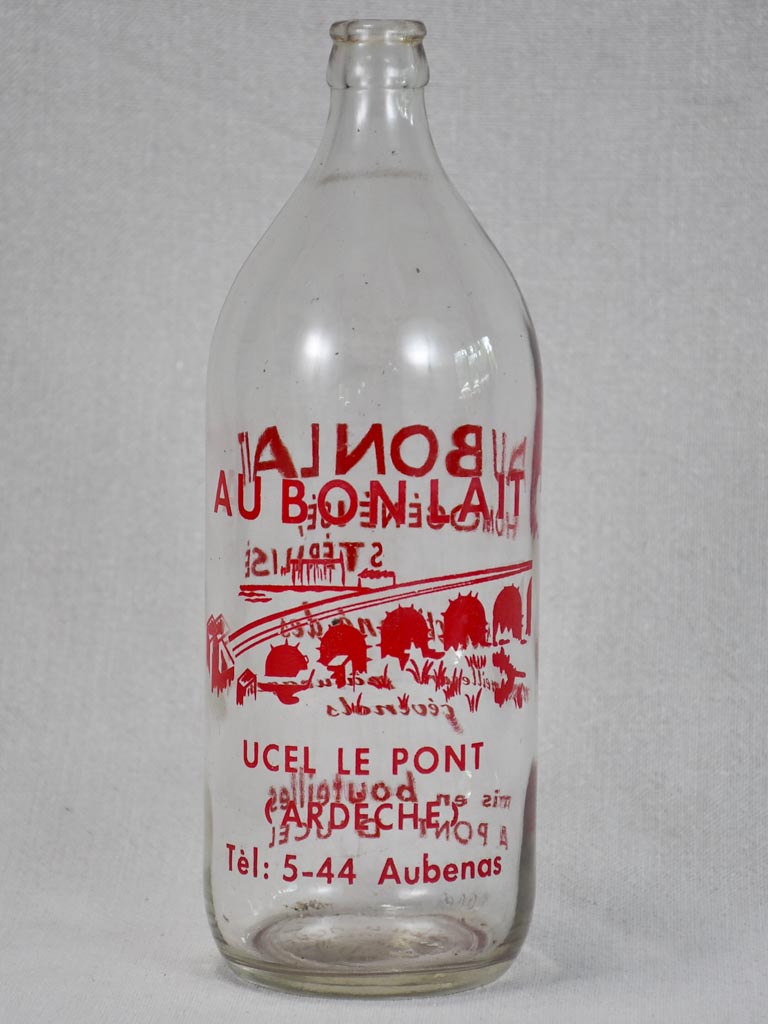 Vintage French consignment milk bottle with red label