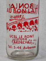 Vintage French consignment milk bottle with red label