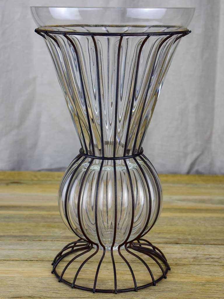Tall blown glass vase in metal frame