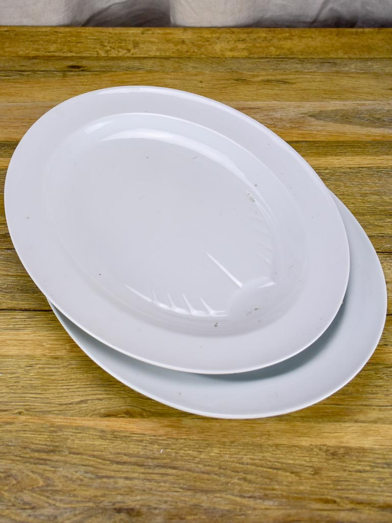 Pair of antique French oval platters with basin for jus