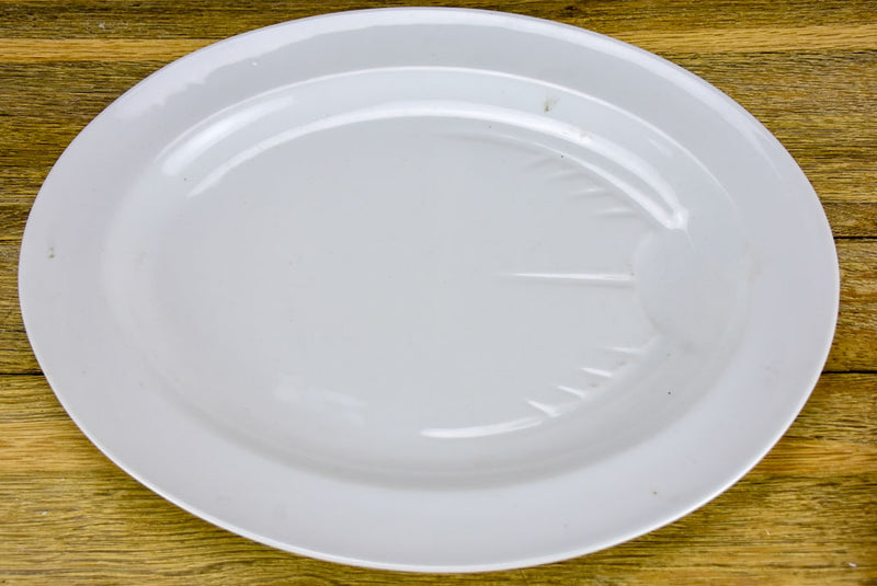Pair of antique French oval platters with basin for jus