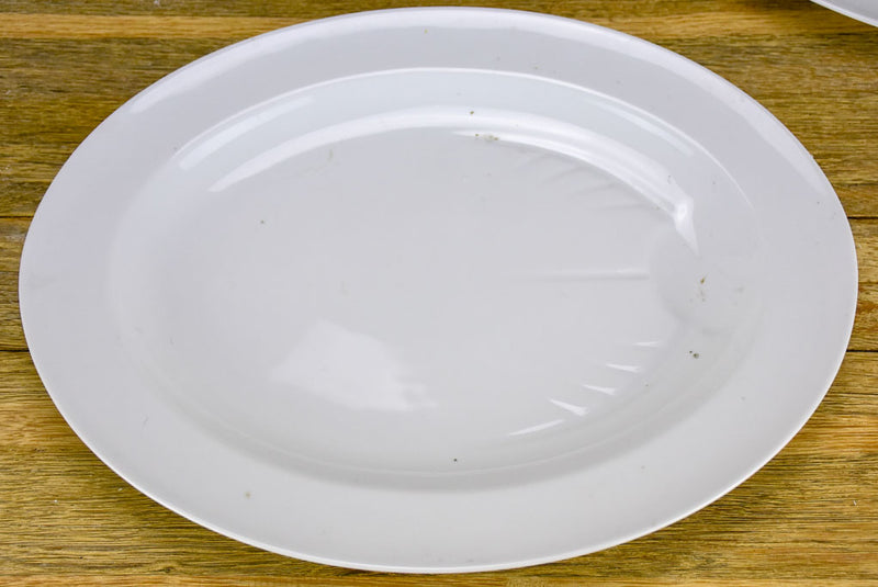 Pair of antique French oval platters with basin for jus