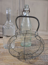 Collection of antique and vintage wire baskets and bottle carriers