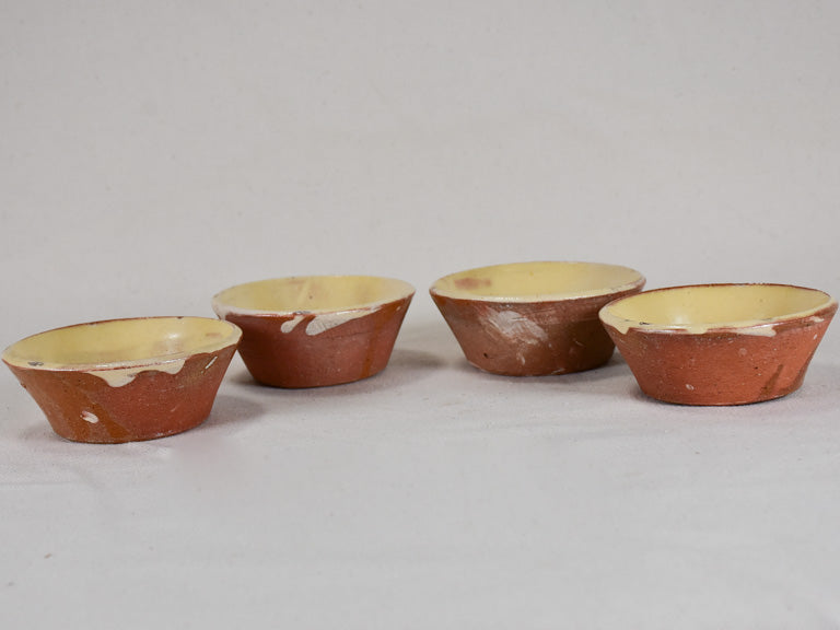 Collection of four small antique French terracotta cheese strainers