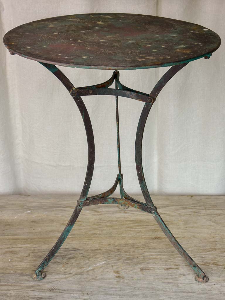 Round antique French garden table with green patina