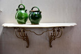 Floating console table with cream marble top and decorative iron base