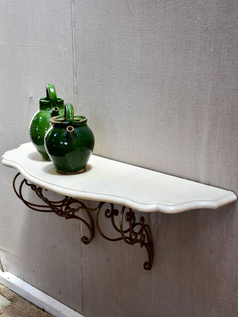 Floating console table with cream marble top and decorative iron base