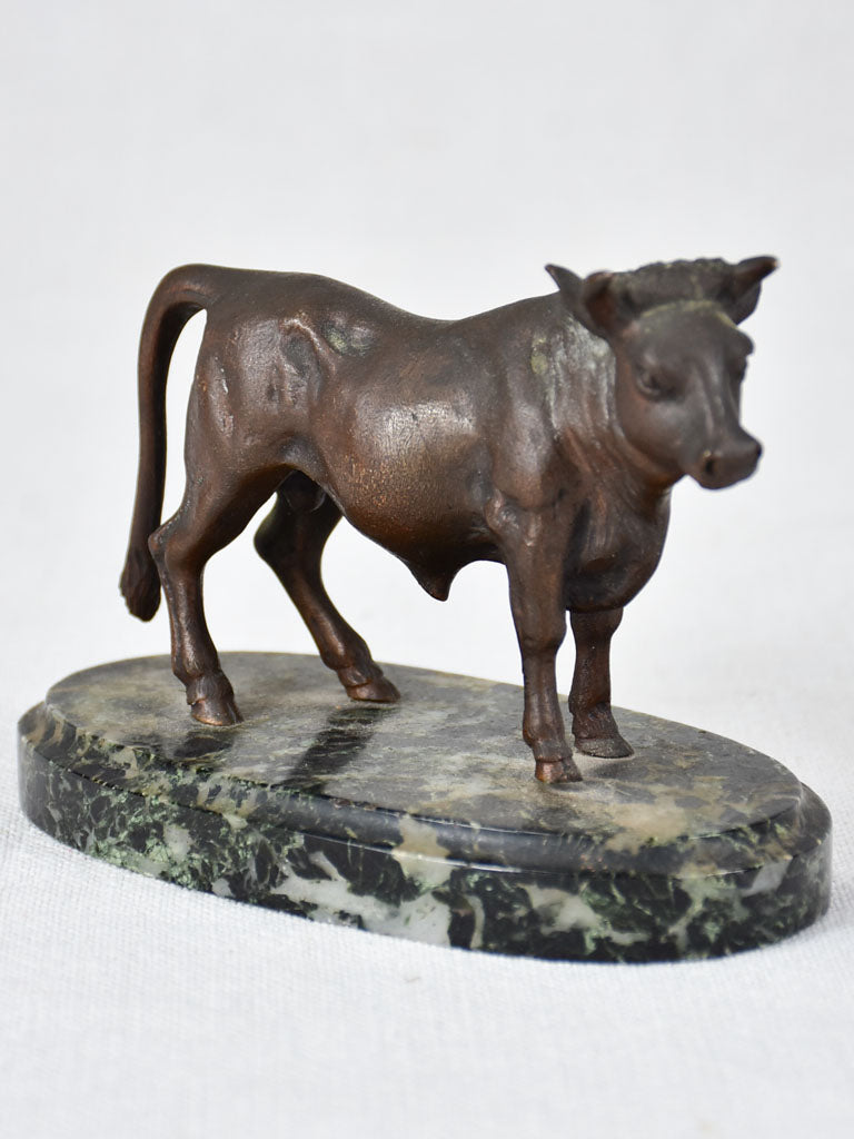 Small bronze statue of a bull on marble base
