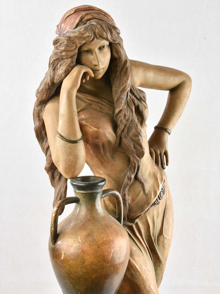 Rebecca leaning on water pot