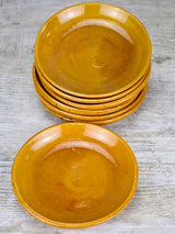 Set of seven mid-century plates with ocher glaze