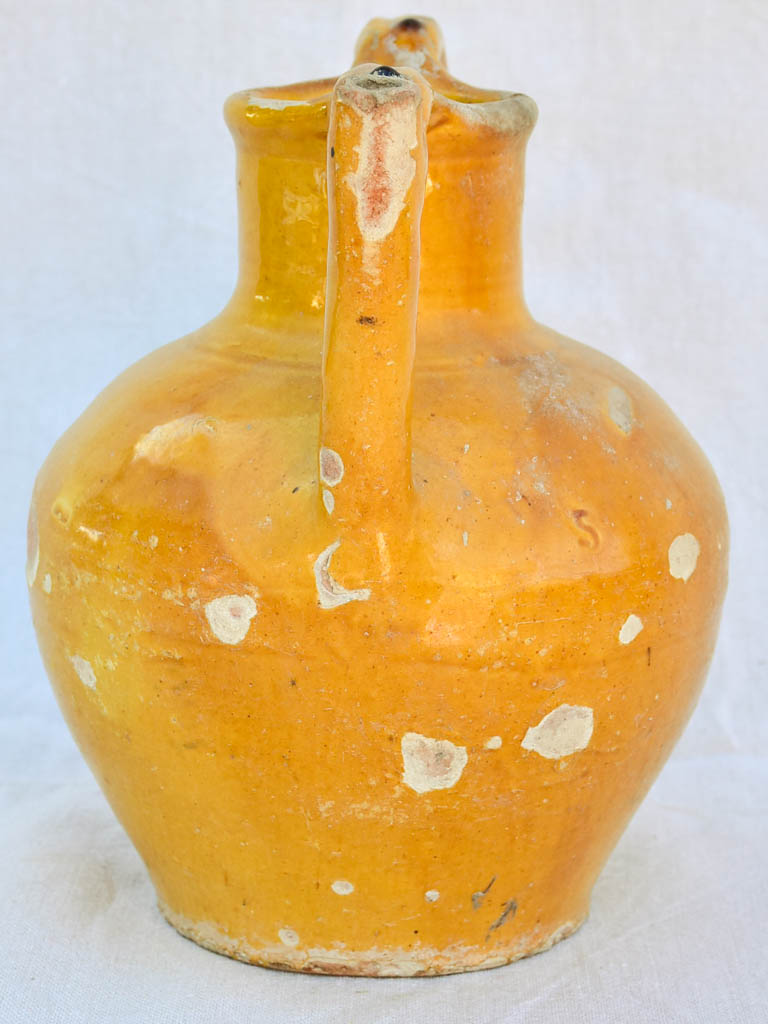 Antique French water pitcher with orange / yellow glaze