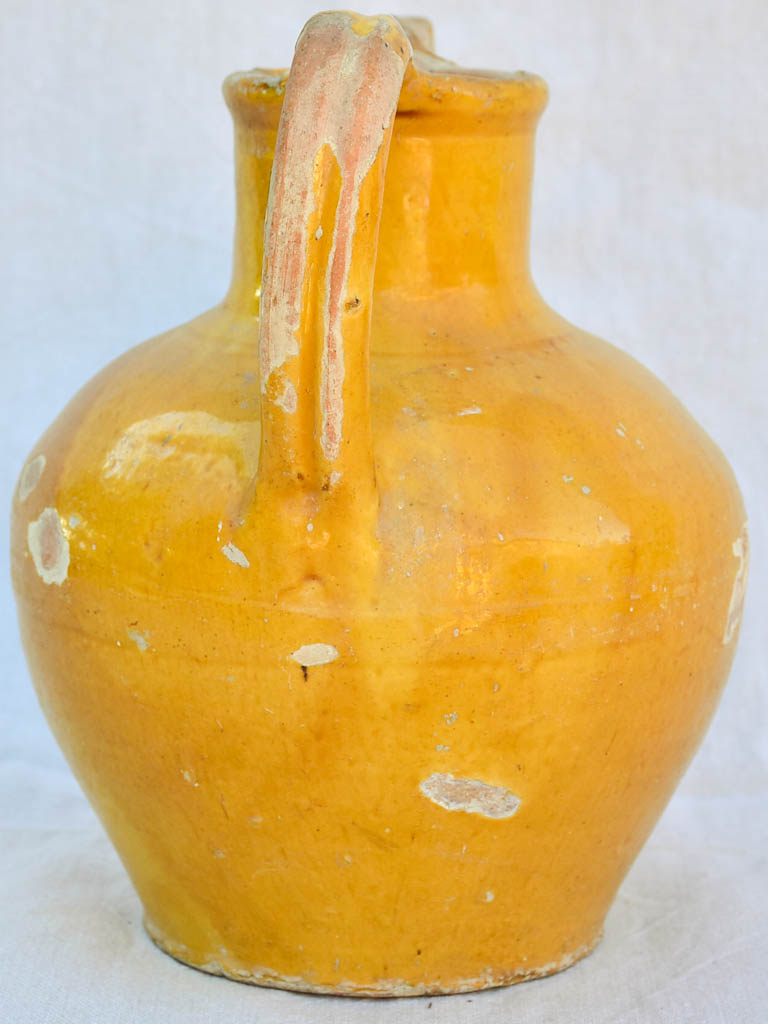 Antique French water pitcher with orange / yellow glaze