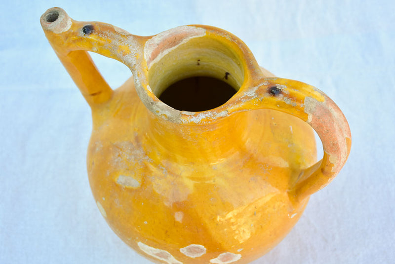 Antique French water pitcher with orange / yellow glaze