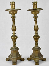 Bronze vintage unevenly paired candlesticks