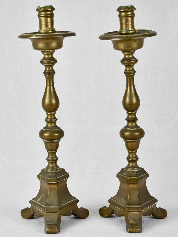 Bronze vintage unevenly paired candlesticks