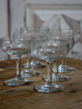 Six antique French champagne cups engraved with bows and garlands