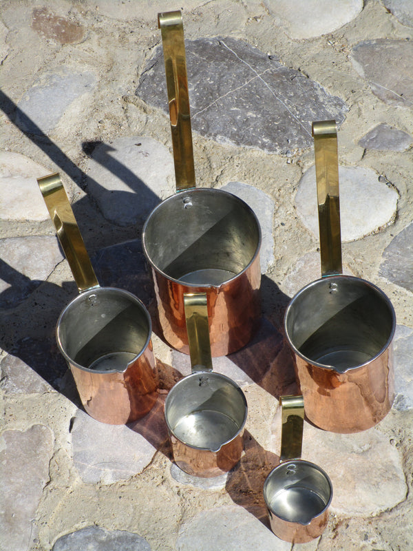 Set of five chef's copper measuring cups tin lined