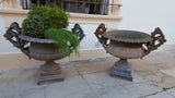 Pair of extra large antique French cast iron Medici urns with overarching handles