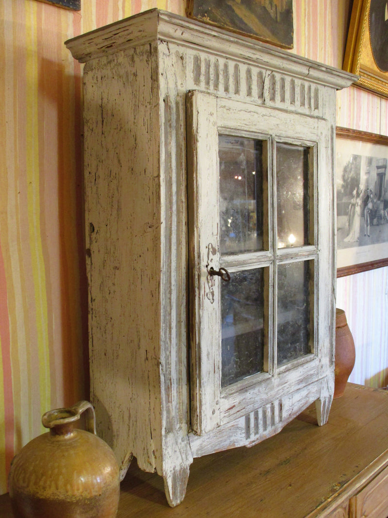 Side view of Rustic French provincial cabinet showcase with french door