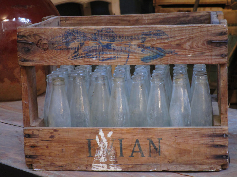 Vintage juice bottles in a rustic wooden box