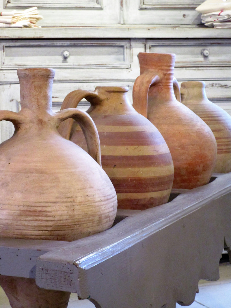 French table with four olive oil jars