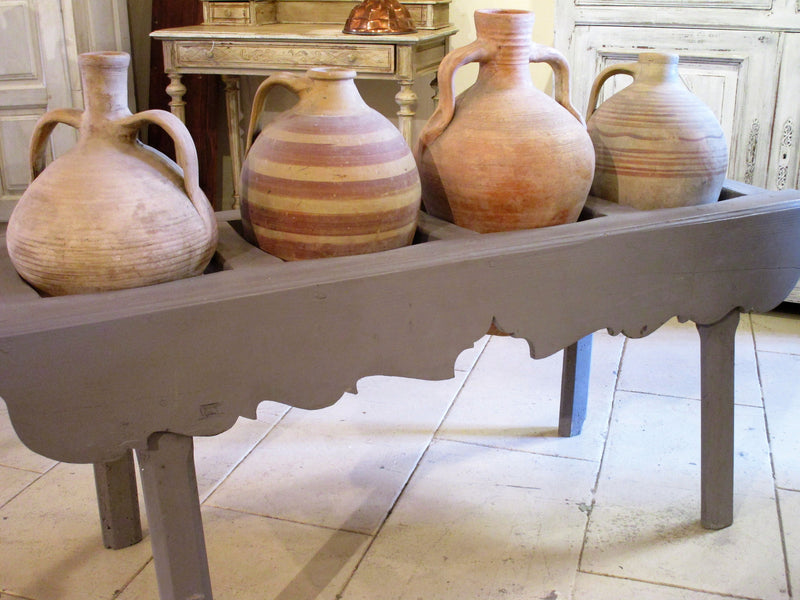 French table with four olive oil jars