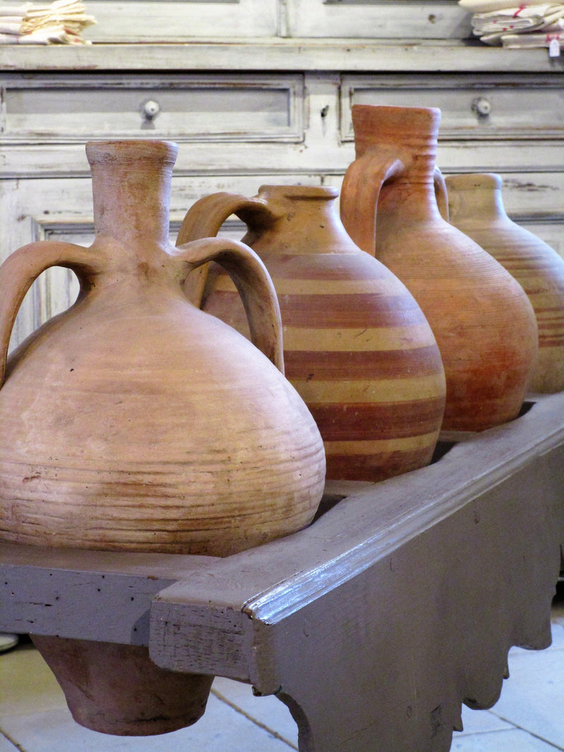 French table with four olive oil jars