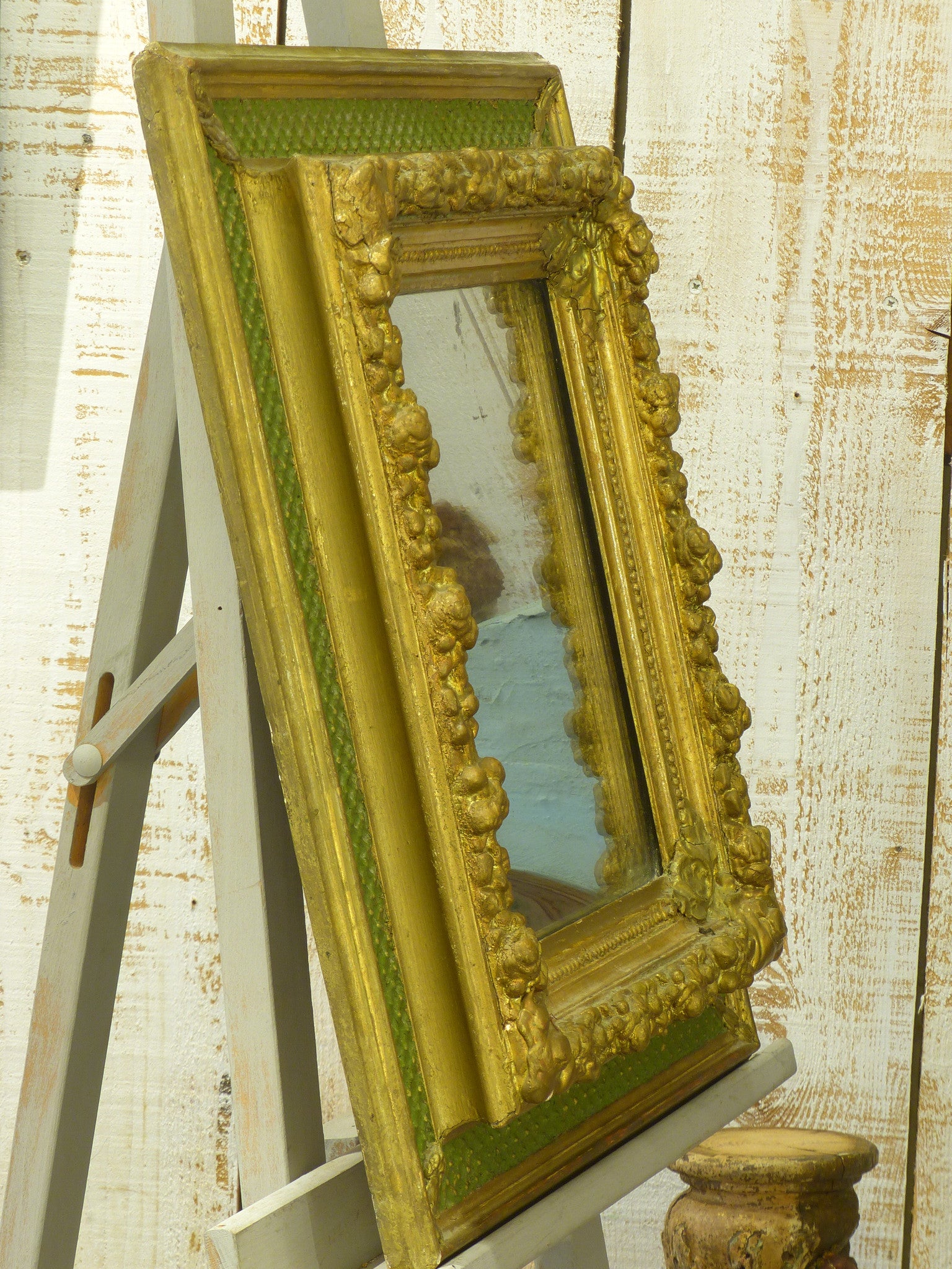 Small Napoleon III mirror with decorative green and gold frame