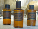 Set of three amber French Apothecary glass jars