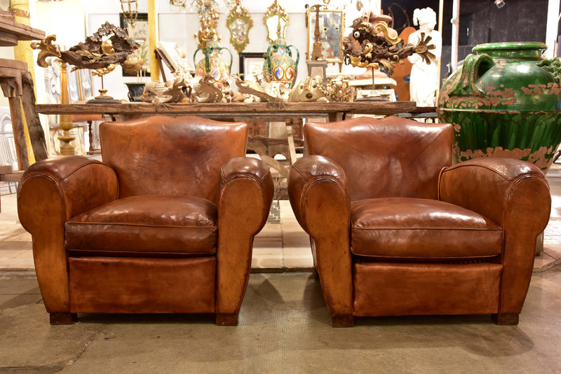 Pair of large vintage French club chairs with mustache back