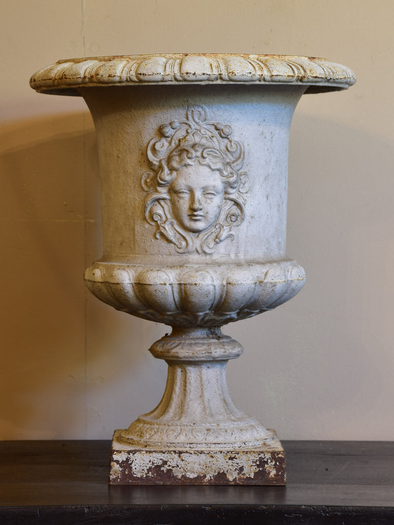 Antique French cast iron garden urn with angel faces
