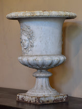 Antique French cast iron garden urn with angel faces